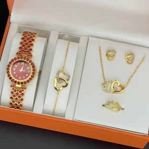 Detailed view of luxury gold heart jewelry set including watch and necklace in gift box
