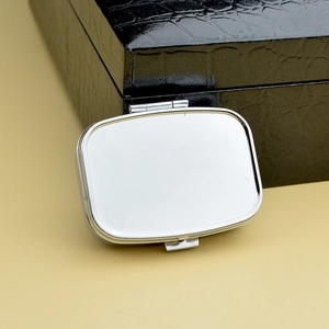 Sleek rectangular silver metal pill box with a polished finish for daily portable storage