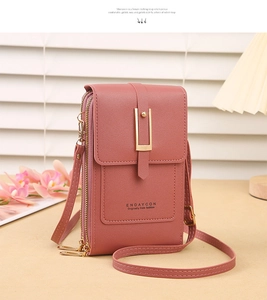 Close-up of lotus pink litchi texture leather phone bag with gold metal clasp detail