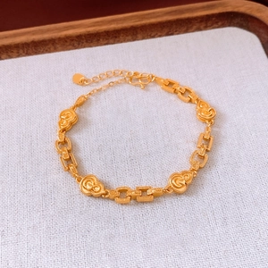 Detail of matte gold calabash bracelet with hollow rectangular links and lobster clasp