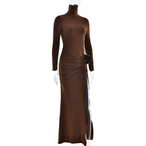 Detailed view of the 3D flower decoration and side slit on the brown high-neck dress