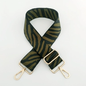 Detail of zebra pattern wide replacement strap with gold metal buckle for bags