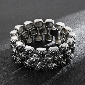 Macro detail of retro stainless steel bracelet with intricate carved cross patterns