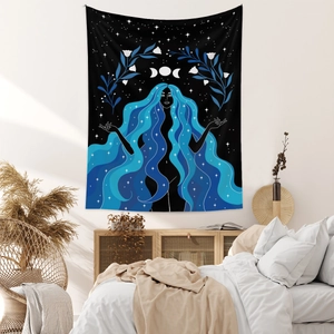 Detailed view of a Bohemian star goddess tapestry hanging above a bedroom headboard