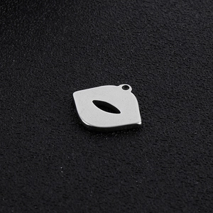 Macro shot of silver lip shaped stainless steel pendant with a polished finish