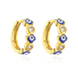 Macro shot of gold hoop earrings featuring blue evil eye charms and cubic zirconia stones