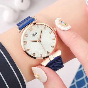 Elegant women's sunburst dial watch with rose gold case and blue magnetic Milanese strap