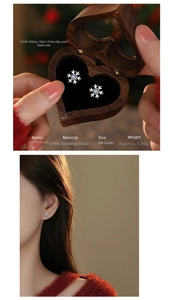 Detail view of S925 sterling silver snowflake earrings in a heart-shaped wooden gift box