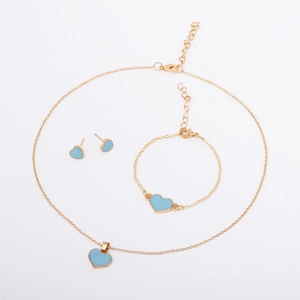 Detail of gold heart jewelry set including blue enamel necklace, bracelet and earrings