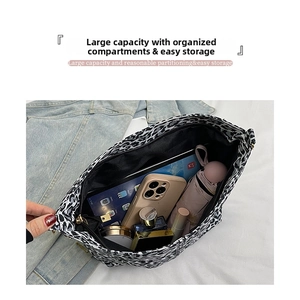 Internal storage detail of leopard print canvas bag showing large capacity for essentials