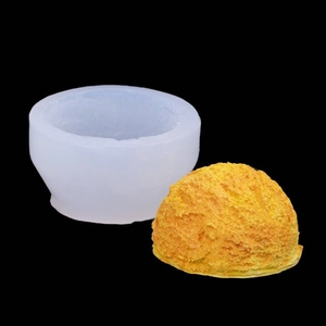 Translucent silicone mold and golden ice cream scoop candle with realistic rough texture