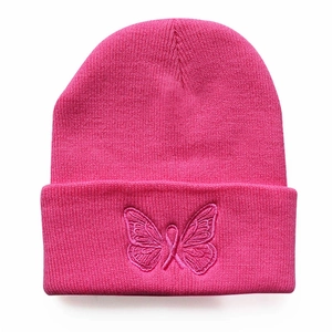 Pink knit beanie for women and men featuring embroidered butterfly and pink ribbon logo