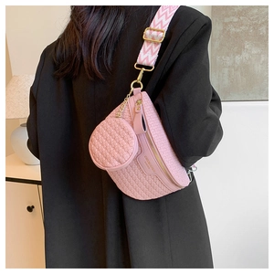 Detail of pink woven texture crossbody bag with adjustable wide chevron strap and gold buckle