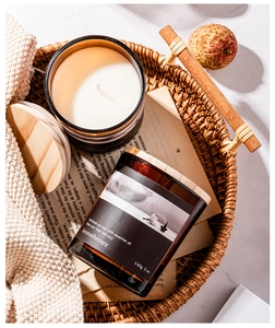 Close-up of a 140g soy wax aromatherapy candle in a dark glass jar with wood lid