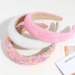 Three padded sponge headbands in pink glitter, white sequins, and colorful candy beads
