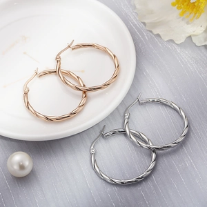 Close-up of twisted rope texture on 30mm titanium steel hoop earrings in rose gold and silver