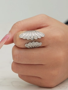 Macro view of shell design open ring with pave set cubic zirconia stones in silver finish