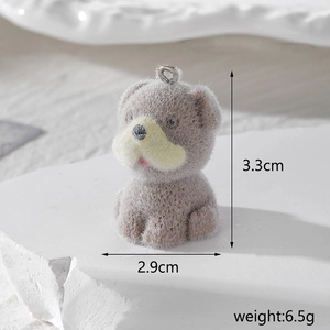 Macro view of a grey flocked dog pendant with size dimensions 3.3cm by 2.9cm