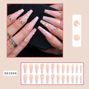 Detail of pink gradient coffin press-on nails with butterfly sequins and small rhinestones