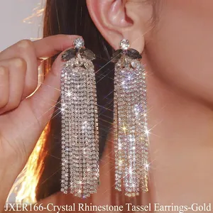 Detailed view of long gold tassel earrings with high-density crystal and rhinestone inlay