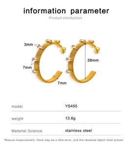 Detail view of gold stainless steel hoop earrings with inlaid rectangular cubic zirconia