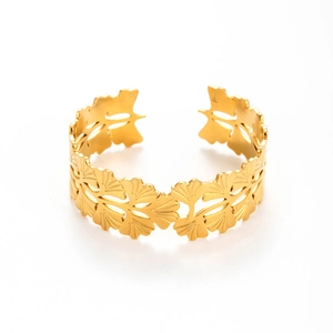 Adjustable golden stainless steel cuff bracelet featuring openwork ginkgo leaf patterns