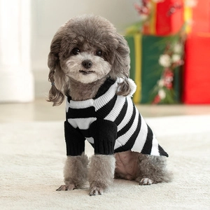 Detailed knit texture of a black and white striped dog sweater in a cozy setting