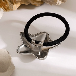 Minimalist high-elastic hair tie with metallic silver star charm on a natural stone base