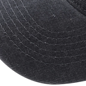 Close-up of black washed denim baseball cap visor with reinforced white stitching lines