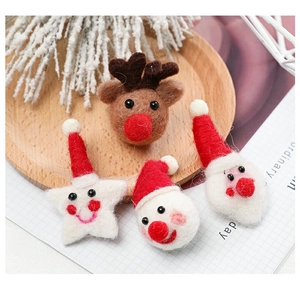 Detailed view of handmade Christmas felt ornaments in a rustic wooden tray for DIY holiday decor