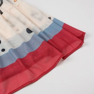 Detail of bohemian floral mesh dress hem with polka dots and colorful stripes