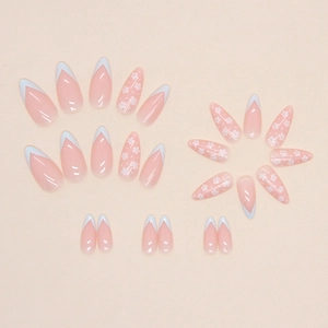 Light blue diagonal French press-on nails with white floral pattern on almond shape