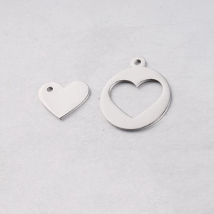 Macro view of silver hollow heart pendant set in polished stainless steel