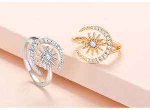 Detail of adjustable sun and moon rings with sparkling cubic zirconia on geometric stands