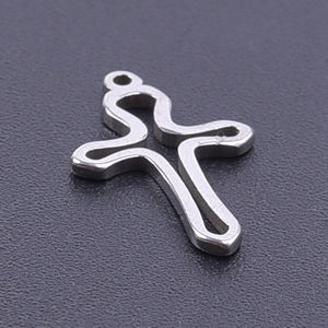 Macro shot of a hollow-out 304 stainless steel cross pendant with polished silver finish