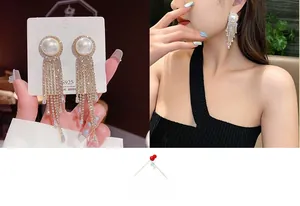Close-up of elegant S925 silver needle tassel earrings with pearls and crystals