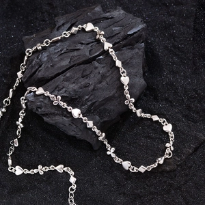 Silver necklace with poker suit heart diamond and clover shaped metal chain links