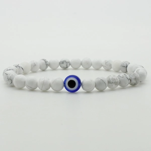 6mm white marble beads bracelet with blue evil eye charm on minimalist background