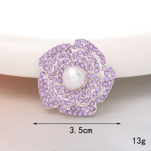 Purple flower brooch with sparkling crystals and a central white pearl, 3.5cm diameter