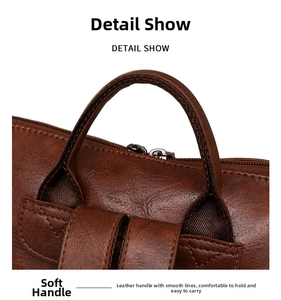 Close-up of soft brown leather handle and reinforced stitching on the vintage backpack