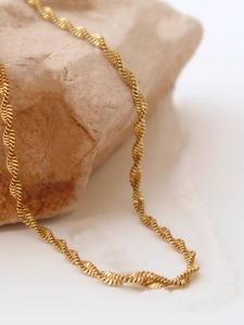 Golden stainless steel twisted wave chain necklace with sparkling textured finish