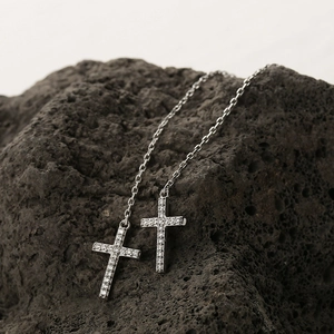 S925 sterling silver cross pull-through earrings with cubic zirconia on black volcanic rock