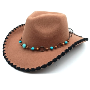 Close-up of turquoise bead band and black braided edge on a wool western cowboy hat