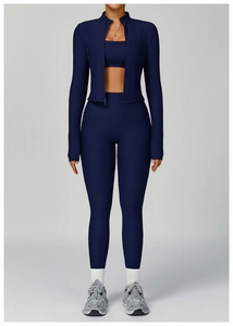 Close-up of navy blue ribbed knit fabric on three-piece yoga set with zipper details