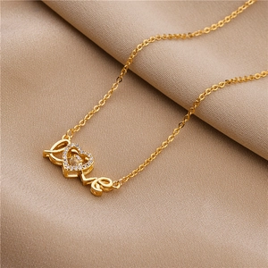 Golden heart pendant necklace with LOVE letters and zircon on a soft beige background