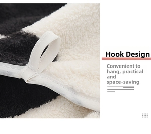 Detail of white hanging loop design on soft black and white coral fleece towel