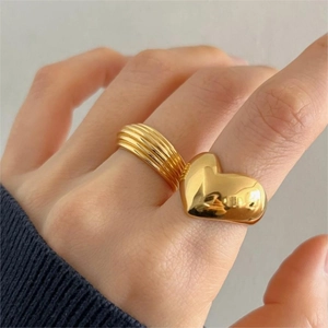 Minimalist 925 sterling silver rings with gold finish and heart motif on hands