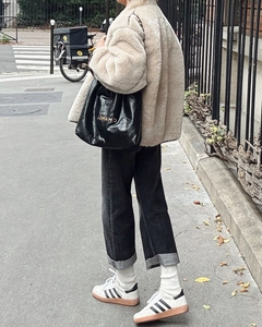 Detail shot of a cozy beige faux fur coat with a large lapel collar for stylish autumn
