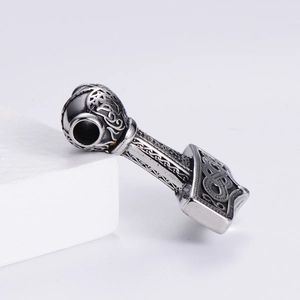 Macro detail of vintage Viking Thor Hammer pendant with hollow pattern and large hole
