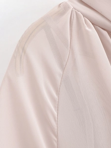 Close-up detail of the shoulder stitching on a pink chiffon evening party dress